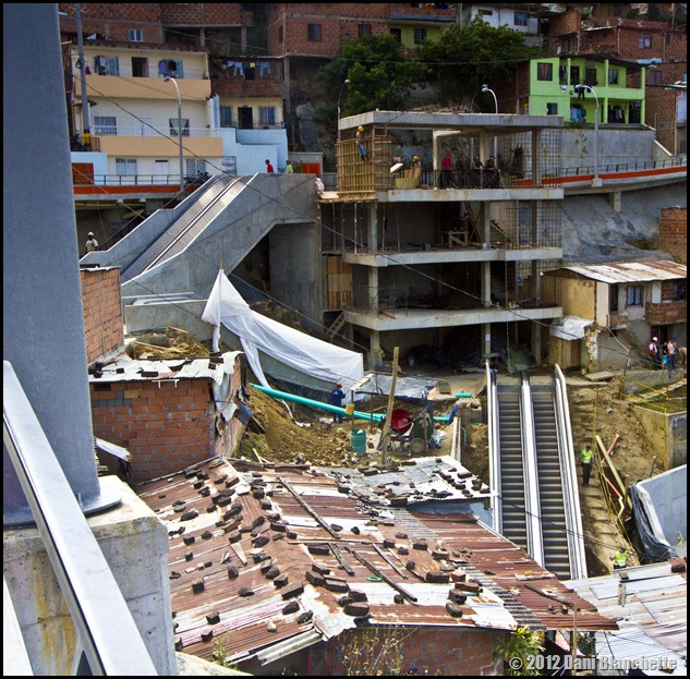 Office buiding and top escalator under construction in Communa 13, Medellin, Colombia. Taken from the new walkway.