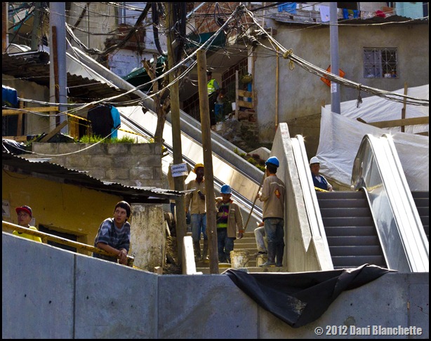 People hang out and watch the construction at the new outdoor escalators in Communa 13, Medellin, Colombia