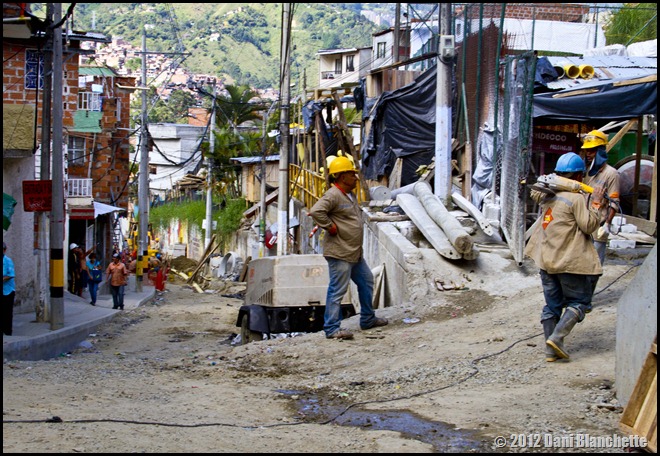 Construstion workers lugging items to storage near the base of the mountainside in Communa 13, Medellin, Colombia