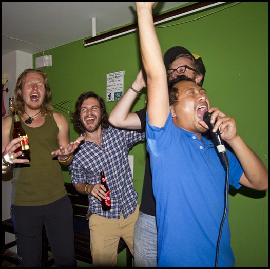 Singing Summer Lovin from Grease - The Wandering Paisa Hostel karaoke night