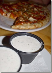 ranch sauce in front of buffalo chicken pizza