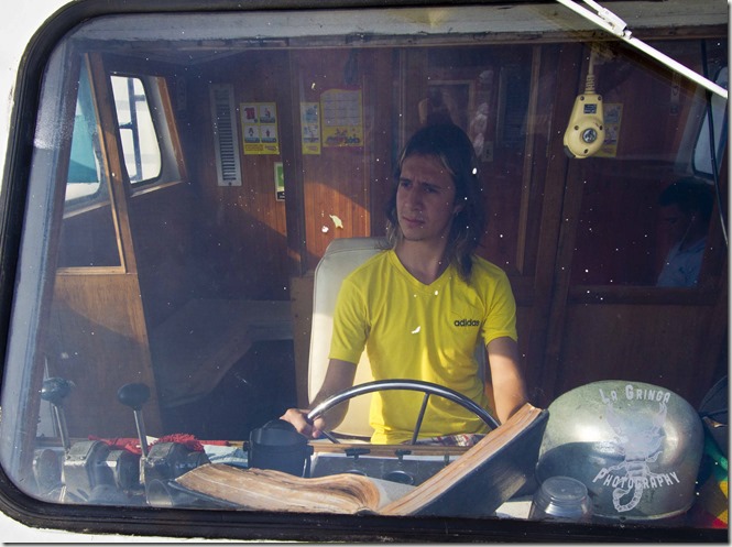 Diego Vasquez, GoingNomadic, La Gringa Photos, Cartagena, Colombia, pretending to drive a boat, sitting at a captains chair