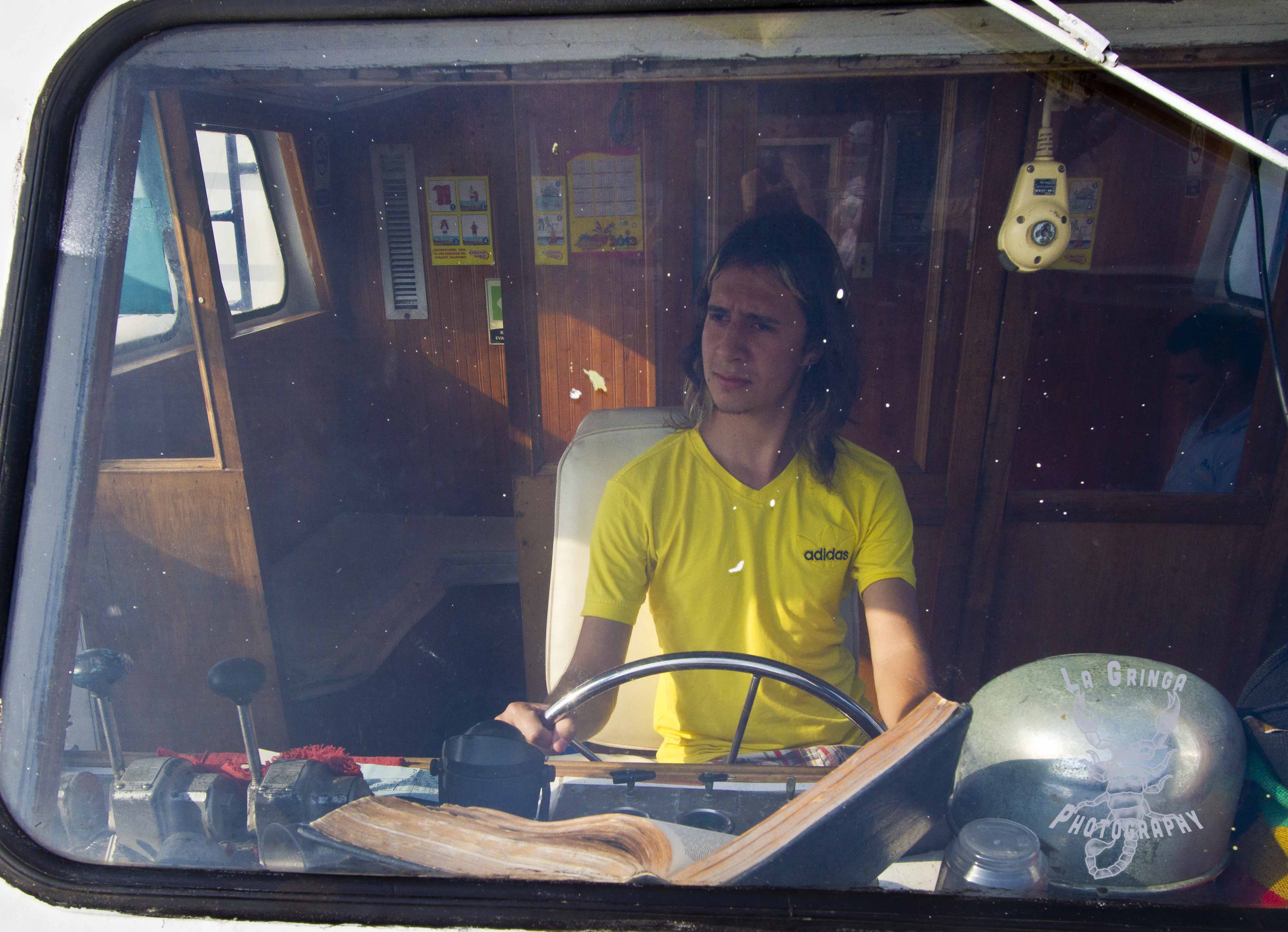 guy in boat captians chair, boat captain, behind the wheel, steering, sailing, 