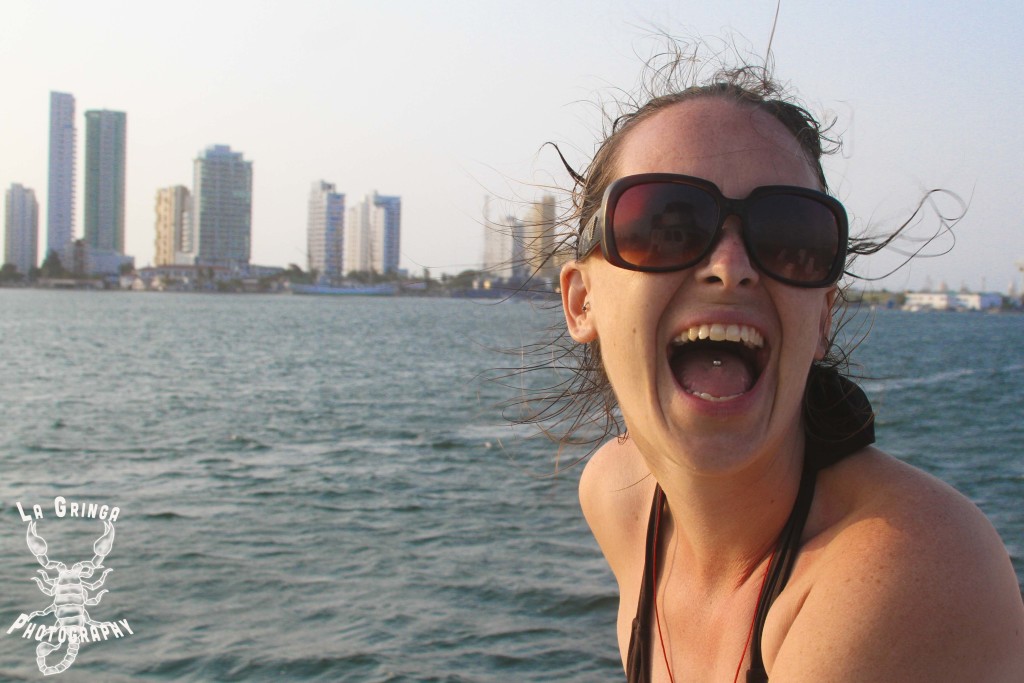 girl laughing with coastal skyline behind her, caribbean, cartagena, colombia