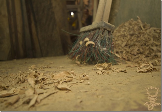 Inside a wood shop, construction, woodworking, medellin, colombia, south america, going nomadic, la gring photos, dani blanchette, wood shavings on the floor, broom, sweep